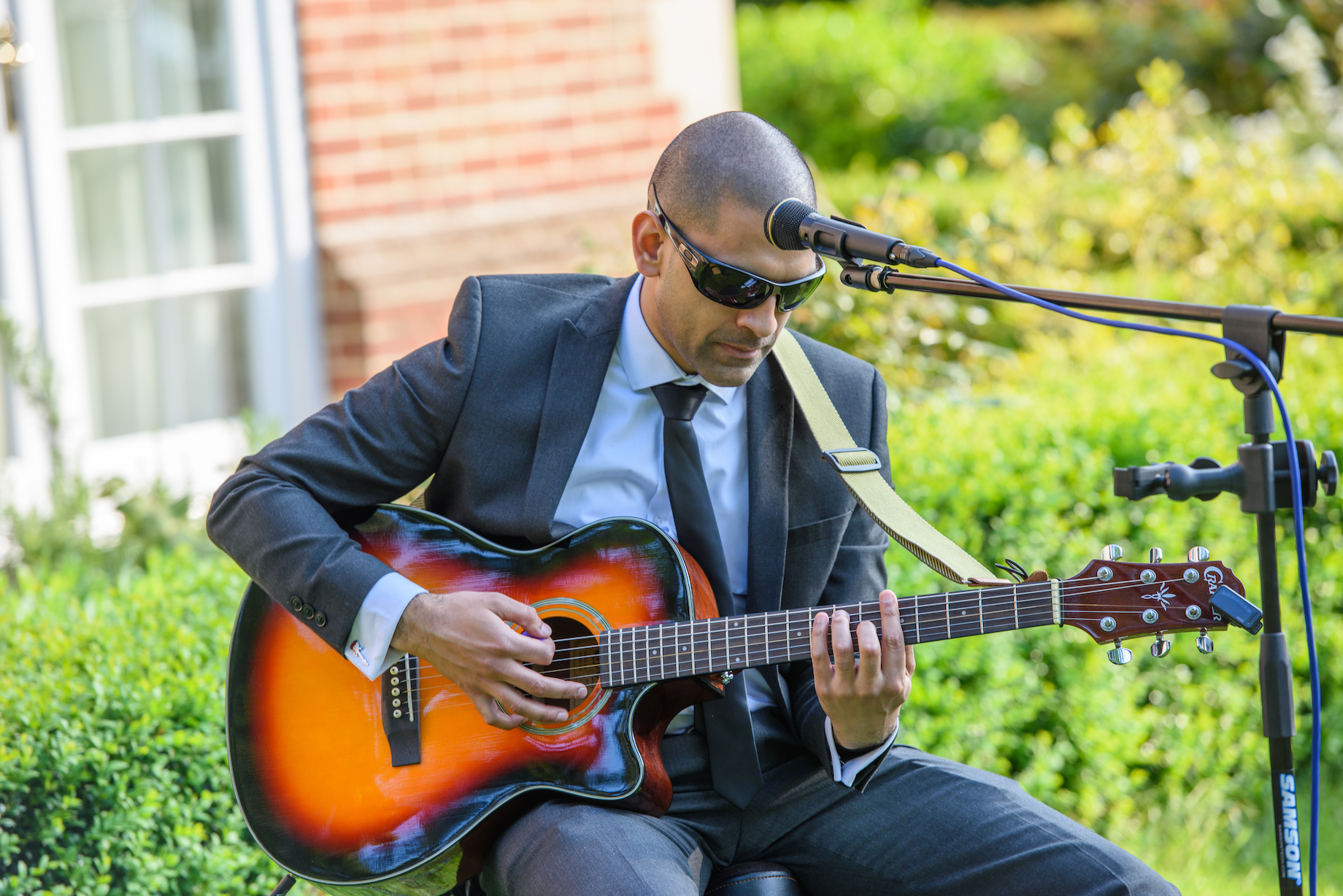 Rol performing acoustic guitar at wedding ceremony